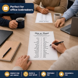 A top-down view of a wooden table with printed game sheets, pens, coffee mugs, and a laptop in a professional office setting. This scene illustrates a team building event in action. Using this icebreaker game helps facilitate a natural meet and greet during work breaks or scheduled social hours.