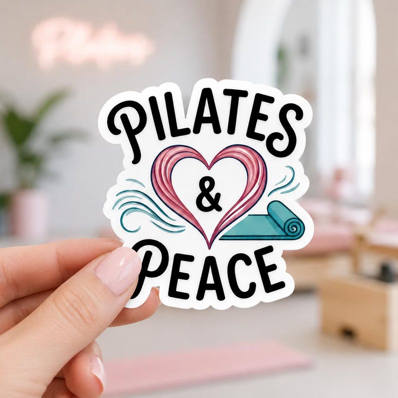 A hand holding a sticker with the text PILATES & PEACE in a black stylized font and a pink heart. This elegant water bottle sticker design combines fitness and mindfulness, making it a lovely gift for yoga and pilates practitioners.