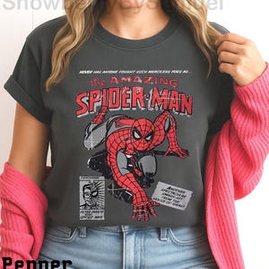 a woman wearing a spider man t - shirt