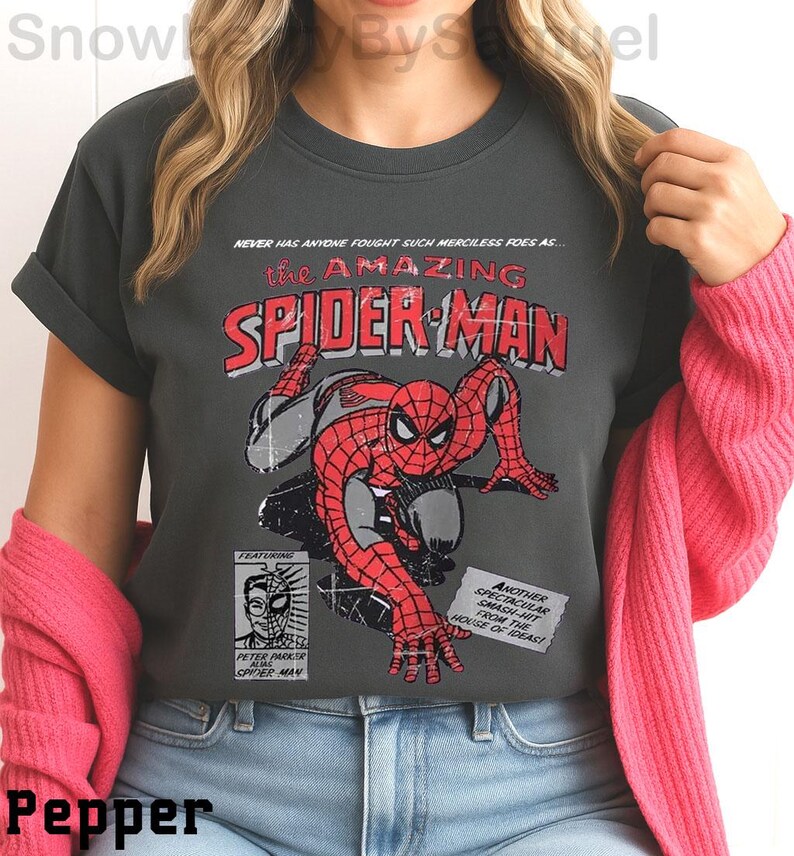 a woman wearing a spider man t - shirt