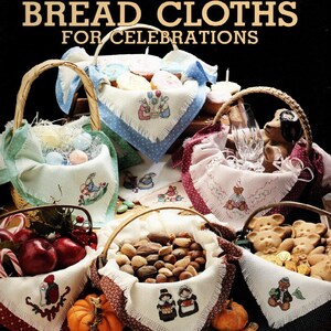 May include: An assortment of woven baskets filled with various items, including eggs, nuts, apples, and cookies. Each basket is lined with a decorative cloth featuring embroidered designs. The text "BREAD CLOTHS FOR CELEBRATIONS" is at the top.