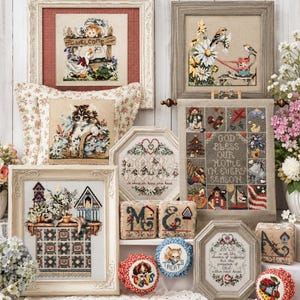 May include: A collection of framed cross-stitch samplers and decorative items. The samplers feature floral, animal, and seasonal themes, with text like "Welcome" and "God Bless Our Home". The color palette includes reds, blues, and greens.