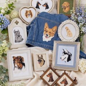 May include: A collection of framed dog portraits and a denim jacket with a Corgi face embroidered on the back. The portraits feature various dog breeds, including a Golden Retriever, Husky, and Doberman Pinschers. The frames are in various shapes and sizes.