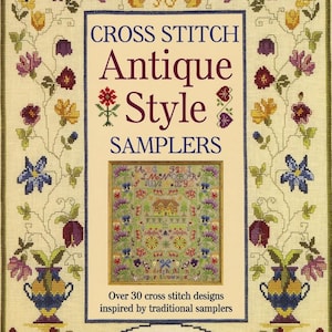 May include: A book cover with the title "CROSS STITCH Antique Style SAMPLERS." The cover features a framed cross-stitch design and floral border. The text "Over 30 cross stitch designs inspired by traditional samplers" is also visible.