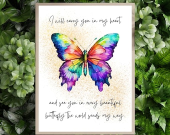 May include: A framed print featuring a watercolor butterfly with vibrant colors of blue, purple, yellow, and red. The butterfly is centered on a white background with text that reads, "I will carry you in my heart, and see you in every beautiful butterfly the world sends my way."