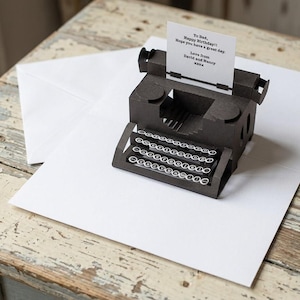 May include: A handmade wooden sign with the text "Welcome" in a playful font. The sign is painted white with a distressed finish, and features a decorative floral design in shades of pink and green. It is designed to be hung on a door or wall.