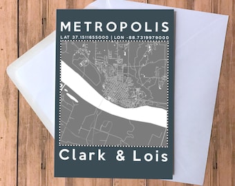 May include: A gray and white map of Metropolis, Illinois with the text "METROPOLIS" and "LAT 37.1511655000 | LON -88.7319979000" above the map and "Clark & Lois" below the map.