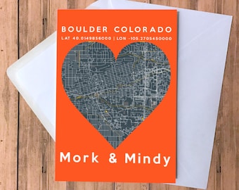May include: A bright orange card with a gray heart-shaped map of Boulder, Colorado. The text "BOULDER COLORADO" is at the top of the card, with the coordinates "LAT 40.0149856000 | LON -105.2705450000" below. The text "Mork & Mindy" is at the bottom of the card.