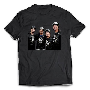 May include: Black t-shirt featuring a photograph of four people wearing baseball uniforms. The uniforms have the letters "LA" and a logo. The people are wearing sunglasses or goggles. The t-shirt is displayed on a white background.