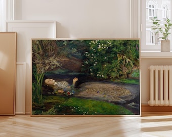 May include: A framed art print of a painting depicting a woman floating in a stream. The artwork features lush greenery, flowers, and a serene water scene. The painting is in a wooden frame.