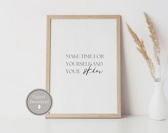 May include: A printable wall art print with a white background and black text that reads "Make time for yourself and your skin". The print is framed in a light wood frame and is displayed on a white surface.