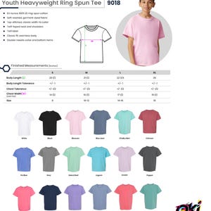 May include: A Comfort Colors youth heavyweight ring spun tee, model 9018, shown in light pink. The image includes a technical diagram with measurements in inches, a list of product features, and a color chart displaying eighteen available shades.