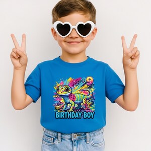Custom Gecko Birthday Boy Shirt, Rainbow 90s inspired Gecko,y2k colorful,Maximalist Adult Kids.Make her milestone truly unique with this customizable neon-rainbow Gecko birthday shirt! Whether she is turning one, seven, or ten, you can personalize this vibrant design with any age to match her special celebration. This eye-catching cub design is perfect for the birthday girl who loves bright colors and wild adventures.