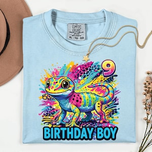 Custom Rainbow Gecko 90s inspired Reptile Birthday Girl Shirt,Comfort,y2k colorful,Maximalist Adult Kids.Make her milestone truly unique with this customizable neon-rainbow Gecko birthday shirt! Whether she is turning one, seven, or ten, you can personalize this vibrant design with any age to match her special celebration. This eye-catching cub design is perfect for the birthday girl who loves bright colors and wild adventures.