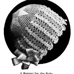May include: A white crocheted bonnet featuring an intricate openwork lace pattern with a scalloped edge and a decorative bow at the base. The text "A Bonnet for the Baby" is printed below the circular image of the headwear.