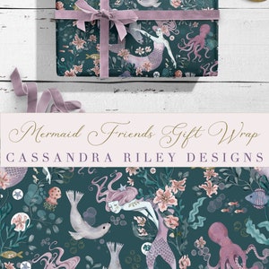 May include: Teal blue wrapping paper with a repeating pattern of mermaids, seals, octopuses, and flowers. The text "Mermaid Friends Gift Wrap" and "CASSANDRA RILEY DESIGNS" is printed on the paper.
