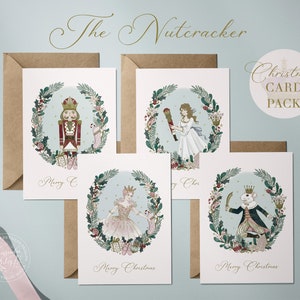 Set of four Christmas cards featuring illustrations from The Nutcracker. Each card features a different character from the ballet: the Nutcracker, Clara, the Sugar Plum Fairy, and the Mouse King. Each card has a wreath of holly and other festive greenery around the character. The cards are printed on white cardstock and have a light blue background. The text "Merry Christmas" is printed on each card.