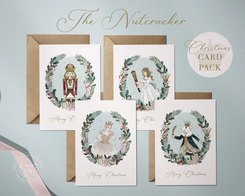 Set of four Christmas cards featuring illustrations from The Nutcracker. Each card features a different character from the ballet: the Nutcracker, Clara, the Sugar Plum Fairy, and the Mouse King. Each card has a wreath of holly and other festive greenery around the character. The cards are printed on white cardstock and have a light blue background. The text "Merry Christmas" is printed on each card.
