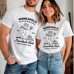 May include: White t-shirts with a black graphic design. The design includes the text "MINNEAPOLIS ONLY YOU CAN DESTROY FASCISM" and a stick figure holding an ice ball. The text "Snowballs Club" is also present.