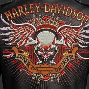 May include: Black leather jacket with a large embroidered Harley-Davidson logo on the back. The logo features a skull with wings, flames, and the text "BIKER TO THE BONE". The Harley-Davidson text is in gold.