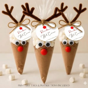 May include: Three festive hot chocolate cones, each resembling a reindeer. They feature brown paper cones filled with cocoa, topped with marshmallows, googly eyes, and pipe cleaner antlers. Each has a tag that reads "Reindeer Hot Cocoa".