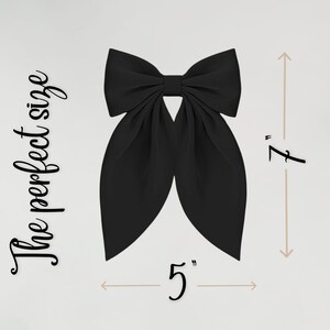 May include: A large, black bow with a classic design. The bow measures 5 inches wide and 7 inches long. The text "The perfect size" is written in a script font on the left side of the bow.