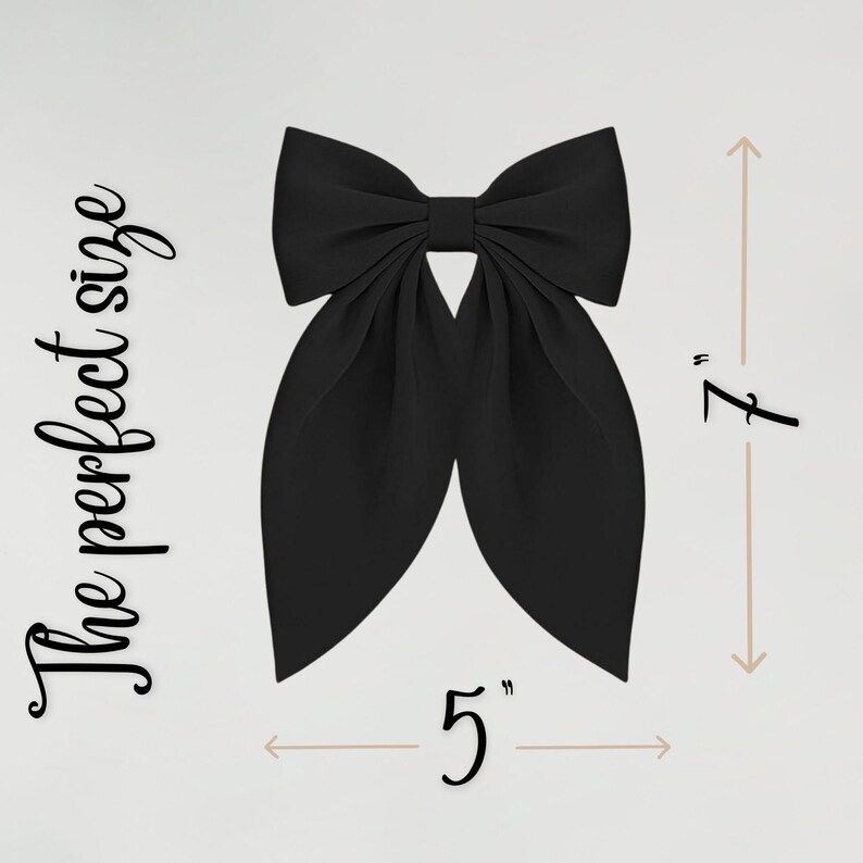 May include: A large, black bow with a classic design. The bow measures 5 inches wide and 7 inches long. The text "The perfect size" is written in a script font on the left side of the bow.