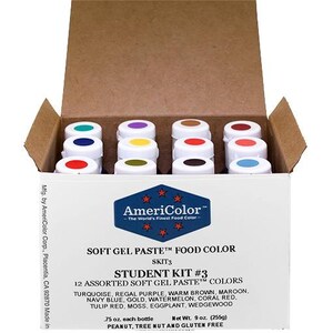 May include: AmeriColor Student Kit #3 with 12 assorted soft gel paste food colors. The box contains small white jars with colored lids, including turquoise, purple, and red. The box is brown and white with the AmeriColor logo.