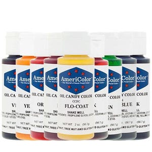 May include: A collection of AmeriColor food coloring bottles in various colors, including yellow, orange, red, green, and blue. Each bottle has a white cap and a label with the brand name and product information. The bottles are 2 oz (56.7 g) each.
