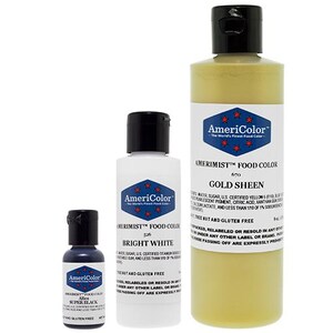 May include: Three AmeriColor food color bottles: Super Black, Bright White, and Gold Sheen. The bottles have black caps and labels with a blue and red star design. The Gold Sheen bottle is the largest.