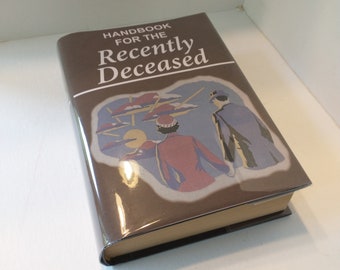 May include: A brown book with the title "Handbook for the Recently Deceased" on the cover. The cover features an illustration of two people walking away from a city with flying saucers in the background.