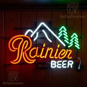 thumbnail image 2 of 1974 Rainier Beer Retro Metal Sign – 70s Man & Mountain Goat – Vintage Look Replica – Wall Decor 2 of 4