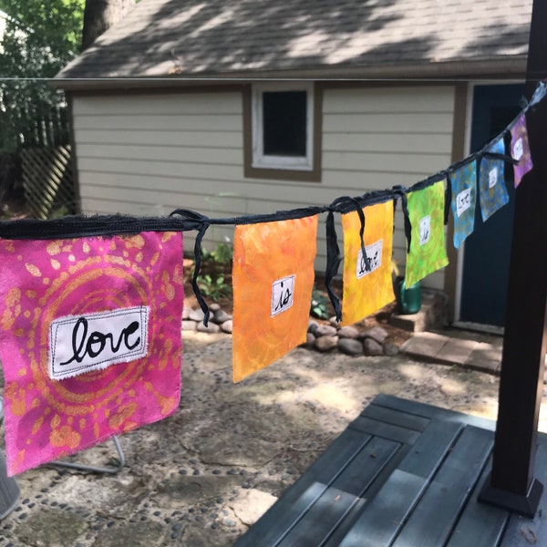 Love Is Love. Rainbow Flag Bunting Supporting LGBTQ Rights. Indoor/Outdoor 7 Flag Garland. Handmade, Handpainted, Stenciled 100% Cotton.