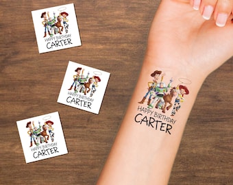 May include: Square temporary tattoos featuring a colourful illustration of Woody, Buzz Lightyear, Bullseye, and Jessie from Toy Story. Below the characters, the text reads HAPPY BIRTHDAY CARTER in black font. One tattoo is applied to a forearm.