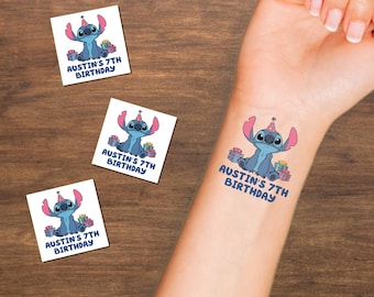 May include: Temporary tattoos featuring a blue cartoon alien with pink ears and a party hat, surrounded by gifts. The text "AUSTIN'S 7TH BIRTHDAY" is printed below the character. Three additional tattoos are visible.