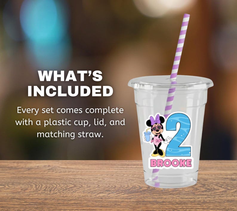 May include: A clear plastic cup with a lid and a purple and white striped straw. The cup features a graphic of a cartoon mouse wearing sunglasses and a pink outfit, a large blue number 2, and the name BROOKE printed in pink capital letters.