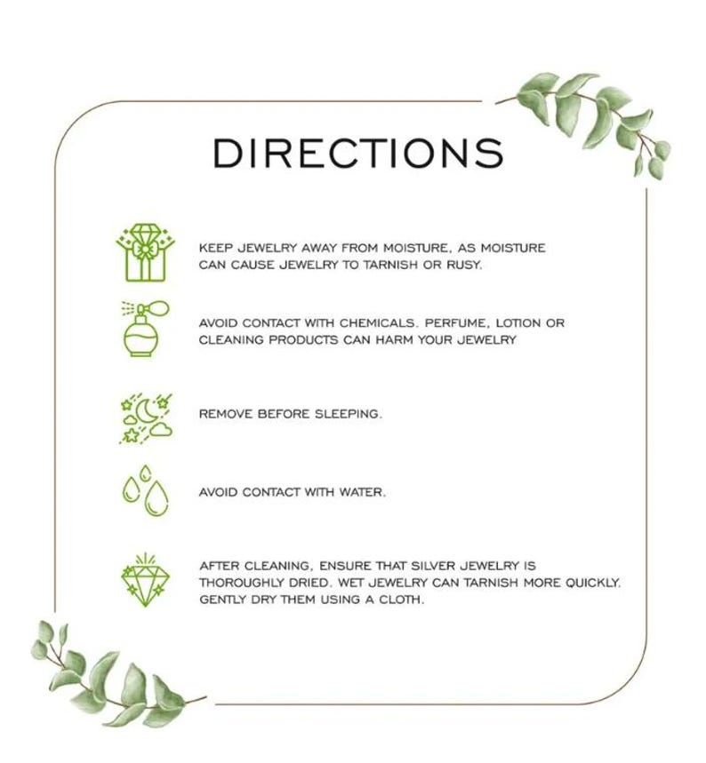 May include: A white card with the word "DIRECTIONS" in black text. The card provides jewelry care instructions, including avoiding moisture, chemicals, and water. It also advises removing jewelry before sleeping and drying it with a cloth after cleaning.