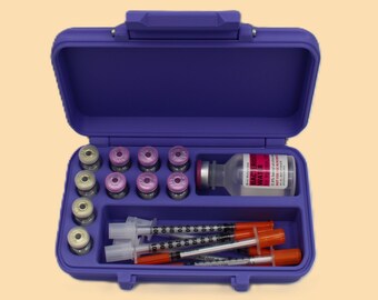 May include: A purple medical case, open to reveal vials, syringes, and a bottle of medication. The case is rectangular with a handle and a divided interior. The vials are arranged in rows, and the syringes have orange caps.