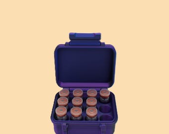 May include: A dark purple carrying case with a handle, open to reveal twelve small glass jars with orange lids. The case has a molded interior to hold the jars securely. The background is a light tan color.