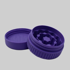 May include: A purple, two-piece container with a textured exterior and interior. The container's lid is separate, revealing the inside design. The interior features a star-shaped design. The container is made of a solid, smooth material.