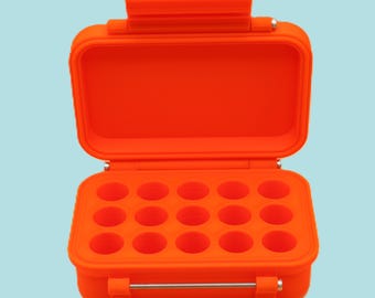 May include: Open orange storage case with a hinged lid and a silver metal clasp. The interior has 15 circular compartments. The case is made of a durable, waterproof material. The case is designed to protect small items.
