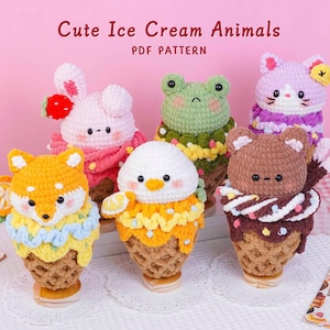 May include: Six crocheted plush toys shaped like animals in ice cream cones, including a fox, rabbit, frog, cat, bear, and bird. The text "Cute Ice Cream Animals PDF PATTERN" is displayed at the top. Each figure features colorful yarn details.