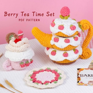 May include: A crocheted tea set with a teapot, teacup, and coaster, all designed to resemble a dessert. The teapot is yellow with white and pink accents, and the teacup is pink. The set is labeled "Berry Tea Time Set PDF Pattern".