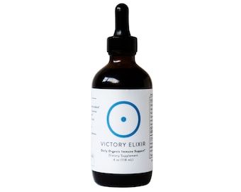 May include: A dark brown glass bottle with a dropper top. The label is white with a blue circle and the text "VICTORY ELIXIR Daily Organic Immune Support* Dietary Supplement 4 oz (118 mL)"