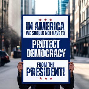 Może przedstawiać: Transparent z napisem "IN AMERICA WE SHOULD NOT HAVE TO PROTECT DEMOCRACY FROM THE PRESIDENT!" w białym tekście na niebiesko-białym tle, z czerwonymi gwiazdami. Transparent jest trzymany przed rozmytą ulicą miejską.