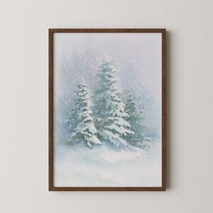 May include: Watercolor painting of a snowy winter scene. The artwork depicts several snow-covered evergreen trees in a forest, with falling snow. The painting is framed in a dark brown wooden frame, creating a serene and wintry atmosphere.