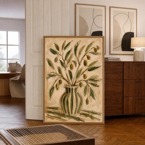May include: A framed vertical wall art print featuring an oil painting of an olive branch arrangement in a striped vase. The artwork uses a palette of muted greens, creams, and earthy browns, depicting textured brushstrokes of leaves and olives.