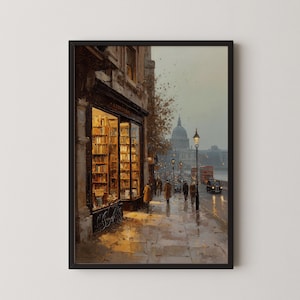 Puede incluir: Impresión enmarcada de una escena callejera londinense. La obra de arte representa una librería con estanterías iluminadas, una calle adoquinada mojada y peatones. Un autobús de dos pisos rojo y la Catedral de San Pablo son visibles.