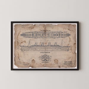 May include: Framed vintage blueprint of the RMS Titanic, showing deck plans and side elevations. The aged paper has stains and a distressed appearance. The blueprint includes the text "R.M.S. TITANIC - GENERAL ARRANGEMENT - HARLAND & WOLFF LTD - APRIL 1912."