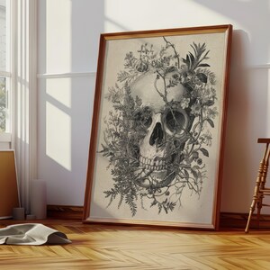 Gothic cottagecore wall art showing nature reclaiming a skeleton skull with detailed leaves and stems.